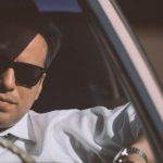 Polished Professionalism. - Businessman in sunglasses driving retro car in town